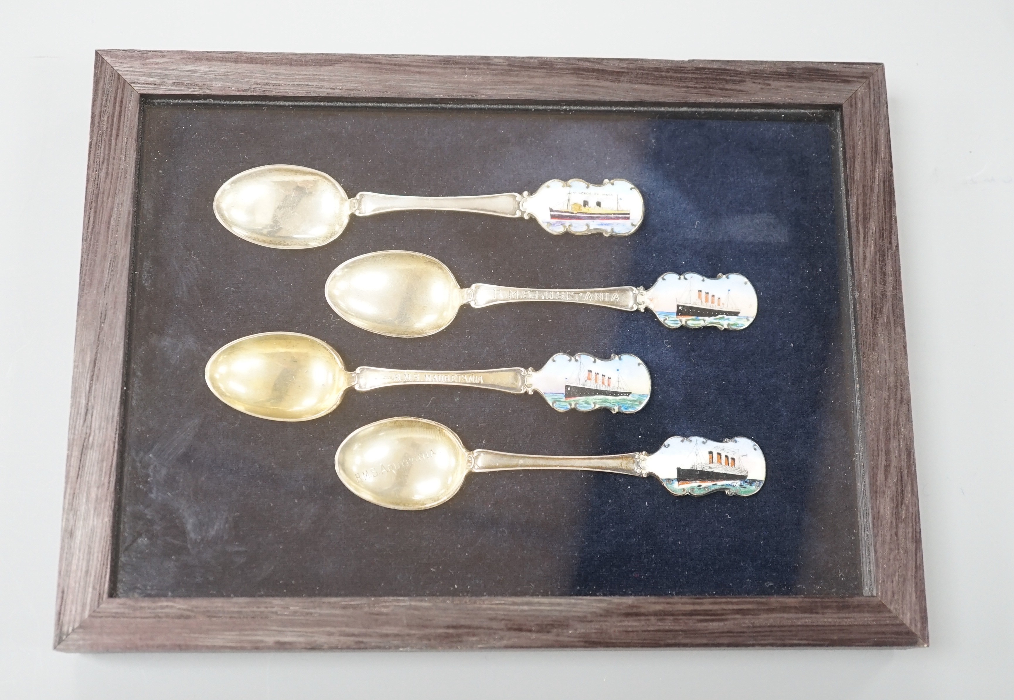 Cunard and P&O liners interest - four early 20th century silver and enamel souvenir spoons, inscribed RMS Lusitania, RMS Aquitania, RMS Mauretania and Viceroy of India, cased